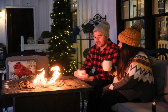 Couple sitting by an outdoor fire pit on a winter evening