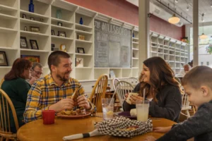 Family dining together at Hillsboro Pub, smiling and enjoying a meal