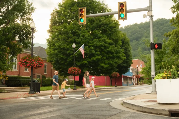 A family walks across the street in Marlinton. 